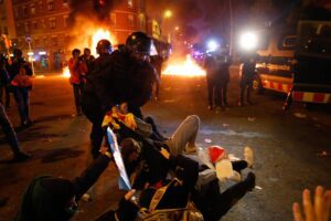 Catalan regional police ‘Mossos D’Esquadra’ officers clash with demonstrators during a protest called by Catalan separatist movement Democratic Tsunami outside the Camp Nou stadium in Barcelona on December 18, 2019, during the "El Clasico" Spanish League football match between Barcelona FC and Real Madrid CF. – Twelve people were injured Wednesday as police charged hundreds of masked protesters who set garbage bins on fire near Barcelona’s Camp Nou stadium, as Barcelona and Real Madrid faced off in the first Clasico of the season, according to emergency services. (Photo by Pau Barrena / AFP) Catalan regional police ‘Mossos D’Esquadra’ officers clash with demonstrators during a protest called by Catalan separatist movement Democratic Tsunami outside the Camp Nou stadium in Barcelona on December 18, 2019, during the "El Clasico" Spanish League football match between Barcelona FC and Real Madrid CF. – Twelve people were injured Wednesday as police charged hundreds of masked protesters who set garbage bins on fire near Barcelona’s Camp Nou stadium, as Barcelona and Real Madrid faced off in the first Clasico of the season, according to emergency services. (Photo by Pau Barrena / AFP)