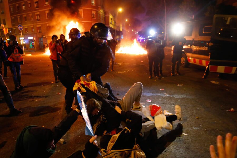 Catalan regional police ‘Mossos D’Esquadra’ officers clash with demonstrators during a protest called by Catalan separatist movement Democratic Tsunami outside the Camp Nou stadium in Barcelona on December 18, 2019, during the "El Clasico" Spanish League football match between Barcelona FC and Real Madrid CF. – Twelve people were injured Wednesday as police charged hundreds of masked protesters who set garbage bins on fire near Barcelona’s Camp Nou stadium, as Barcelona and Real Madrid faced off in the first Clasico of the season, according to emergency services. (Photo by Pau Barrena / AFP)