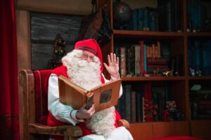 Santa Claus poses at his office near Rovaniemi, Finnish Lapland, on December 2, 2019. – Rovaniemi’s Santa Claus Village amusement park is a snow-covered wonderland of reindeer rides, ice castles, souvenir shops, snowmobiles and igloo hotels where Christmas holds sway 365 days a year. But Lapland is also the homeland of the indigenous reindeer-herding Sami people, who protest that some in the tourist industry spread offensive stereotypes about Sami people and seek to profit from their ancient culture. (Photo by Jonathan NACKSTRAND / AFP) Santa Claus poses at his office near Rovaniemi, Finnish Lapland, on December 2, 2019. – Rovaniemi’s Santa Claus Village amusement park is a snow-covered wonderland of reindeer rides, ice castles, souvenir shops, snowmobiles and igloo hotels where Christmas holds sway 365 days a year. But Lapland is also the homeland of the indigenous reindeer-herding Sami people, who protest that some in the tourist industry spread offensive stereotypes about Sami people and seek to profit from their ancient culture. (Photo by Jonathan NACKSTRAND / AFP)