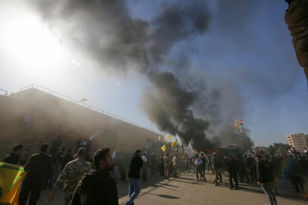 Members of the Iraqi pro-Iranian Hashed al-Shaabi group and protesters set ablaze a sentry box in front of the US embassy building in the capital Baghdad to protest against the weekend’s air strikes by US planes on several bases belonging to the Hezbollah brigades near Al-Qaim, an Iraqi district bordering Syria, on December 31, 2019. – Several thousand Iraqi protesters attacked the US embassy in Baghdad on today, breaching its outer wall and chanting "Death to America!" in anger over weekend air strikes that killed pro-Iran fighters. (Photo by Ahmad AL-RUBAYE / AFP)