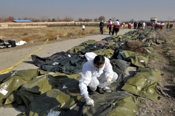 A forensic investigator works at the scene of a Ukrainian plane crash as bodies of the victims are collected, in Shahedshahr, southwest of the capital Tehran, Iran, Wednesday, Jan. 8, 2020. A Ukrainian airplane carrying 176 people crashed on Wednesday shortly after takeoff from Tehran’s main airport, killing all onboard. (AP Photo/Ebrahim Noroozi)