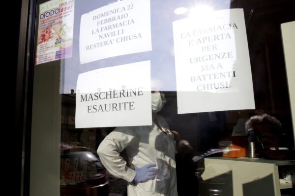 A note reading in Italian " Masks sold out " hangs on the window of a pharmacy in Codogno, near Lodi, Northern Italy, Saturday, Feb. 22, 2020. A dozen towns in northern Italy are on effective lockdown after the new virus linked to China claimed a first fatality in Italy and sickened an increasing number of people. The secondary contagions have prompted local authorities in towns of Lombardy and Veneto to order schools, businesses, and restaurants closed, and to cancel sporting events and Masses. (AP Photo/Luca Bruno)