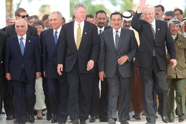 FILE – In this March 13, 1996 file photo, Russian President Boris Yeltsin waves as he and (from left to right) Jordan’s King Hussein, Israeli Prime Minister Shimon Peres, U.S. President Bill Clinton, Egyptian President Hosni Mubarak and far right, PLO Leader Yasser Arafat make their way up to pose for the group photo at the end of their one-day Summit for Peacemakers in Sharm el Sheikh, Egypt. Egypt’s state TV said Tuesday, Feb. 25, 2020, that the country’s former President Hosni Mubarak, ousted in the 2011 Arab Spring uprising, has died at 91. Mubarak, who was in power for almost three decades, was forced to resign on Feb. 11, 2011, after following 18 days of protests around the country. (AP Photo/Jerome Delay, File)