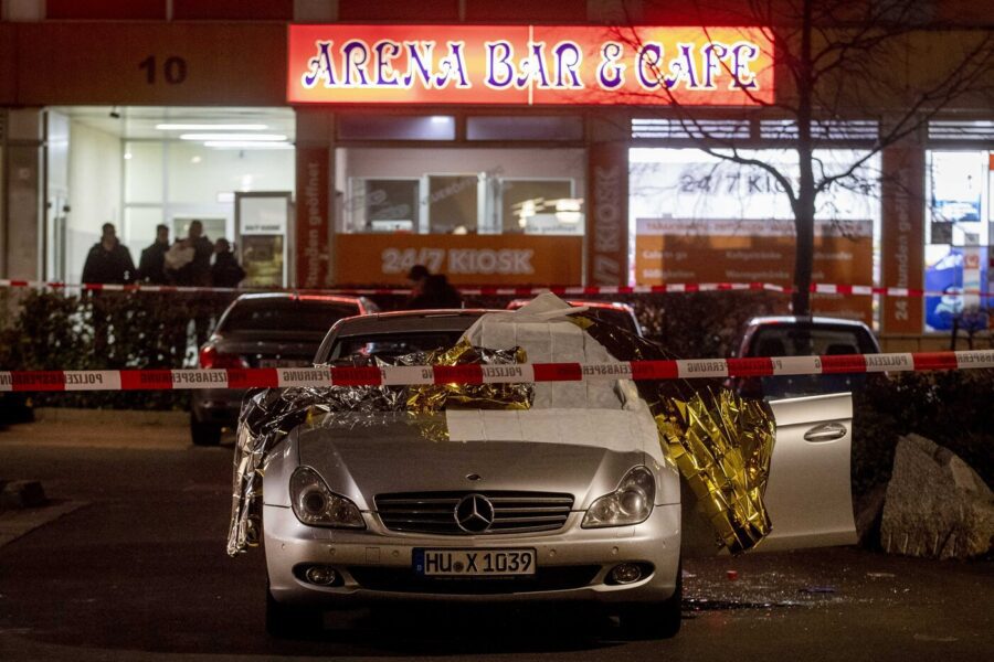 A car with dead bodies stands in front of a bar in Hanua, Germany Thursday, Feb. 20, 2020. German police say several people were shot to death in the city of Hanau on Wednesday evening. (AP Photo/Michael Probst)