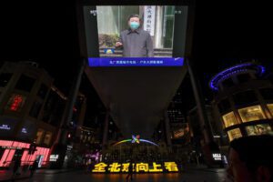 People walk by a giant TV screen broadcasting news of Chinese President Xi Jinping talking to medical workers at the Huoshenshan Hospital in Wuhan in central China’s Hubei Province, at a quiet shopping mall in Beijing, Tuesday, March 10, 2020. Xi visited the center of the global virus outbreak Tuesday. For most people, the new coronavirus causes only mild or moderate symptoms, such as fever and cough. For some, especially older adults and people with existing health problems, it can cause more severe illness, including pneumonia. (AP Photo/Andy Wong)