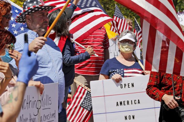 People gather outside the Missouri Capitol to protests stay-at-home orders put into place due to the COVID-19 outbreak Tuesday, April 21, 2020, in Jefferson City, Mo. Several hundred attended the rally to protest the restrictions and urge the reopening of businesses closed in an effort to slow the spread of the coronavirus . (AP Photo/Jeff Roberson)