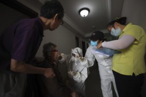 A medical worker takes a swab from a resident for the coronavirus test during home visits in Wuhan the epicenter of China’s coronavirus outbreak in central China’s Hubei province, Thursday, May 14, 2020. Some residential compounds in Wuhan have begun testing inhabitants for the coronavirus as a program to test everyone in the Chinese city of 11 million people in 10 days got underway (Chinatopix via AP) A medical worker takes a swab from a resident for the coronavirus test during home visits in Wuhan the epicenter of China’s coronavirus outbreak in central China’s Hubei province, Thursday, May 14, 2020. Some residential compounds in Wuhan have begun testing inhabitants for the coronavirus as a program to test everyone in the Chinese city of 11 million people in 10 days got underway (Chinatopix via AP)