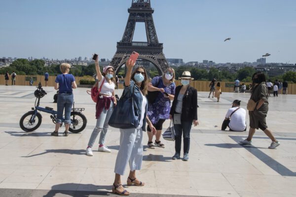 People wear face masks as they make a selfie at Trocadero square with the Eiffel Tower in Paris, Sunday, May 17, 2020 as France gradually lifts its Covid-19 lockdown. Parisians enjoying their first weekend in the sun since travel and movement restrictions were partially lifted. (AP Photo/Michel Euler) People wear face masks as they make a selfie at Trocadero square with the Eiffel Tower in Paris, Sunday, May 17, 2020 as France gradually lifts its Covid-19 lockdown. Parisians enjoying their first weekend in the sun since travel and movement restrictions were partially lifted. (AP Photo/Michel Euler)