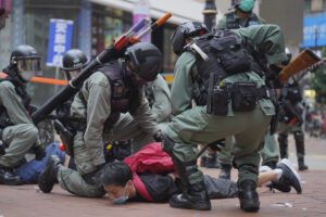 Riot police detain a protester during a demonstration against Beijing’s national security legislation in Causeway Bay in Hong Kong, Sunday, May 24, 2020. Hong Kong police fired volleys of tear gas in a popular shopping district as hundreds took to the streets Sunday to march against China’s proposed tough national security legislation for the city. (AP Photo/Vincent Yu)