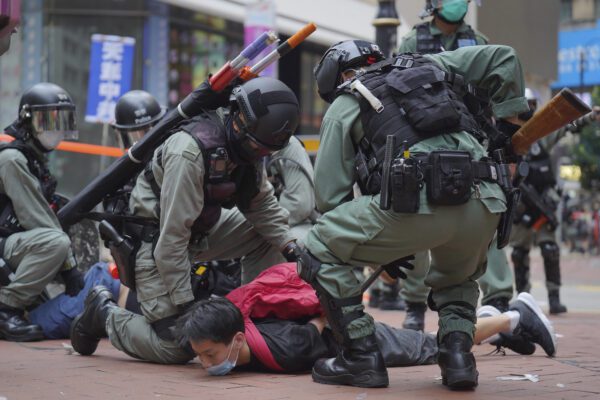 Riot police detain a protester during a demonstration against Beijing’s national security legislation in Causeway Bay in Hong Kong, Sunday, May 24, 2020. Hong Kong police fired volleys of tear gas in a popular shopping district as hundreds took to the streets Sunday to march against China’s proposed tough national security legislation for the city. (AP Photo/Vincent Yu)