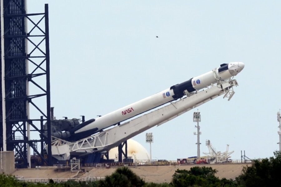 The SpaceX Falcon 9, with the Crew Dragon spacecraft on top of the rocket, is raised onto Launch Pad 39-A Tuesday, May 26, 2020, at Kennedy Space Center, Fla. Two astronauts will fly on the SpaceX Demo-2 mission to the International Space Station scheduled for launch on May 27. (AP Photo/David J. Phillip)