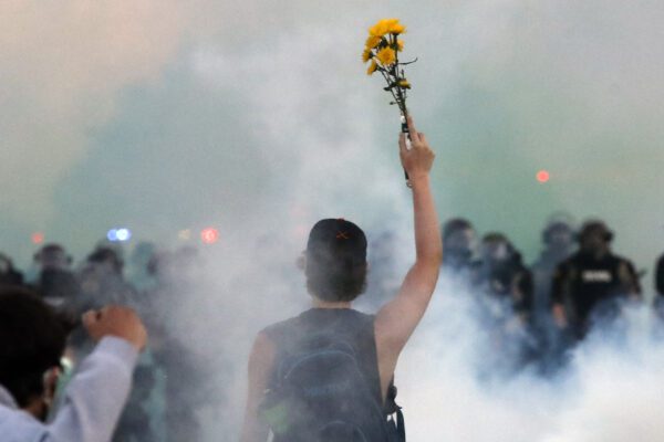 Police approach people to clear an area after curfew Saturday, May 30, 2020, in Minneapolis. Protests continued following the death of George Floyd, who died after being restrained by Minneapolis police officers on Memorial Day. (AP Photo/John Minchillo)