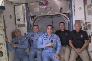 This photo provided by NASA shows Bob Behnken and Doug Hurley, far right, joining the the crew at the International Space Station, after the SpaceX Dragon capsule pulled up to the station and docked Sunday, May 31, 2020.  The Dragon capsule arrived Sunday morning, hours after a historic liftoff from Florida. It’s the first time that a privately built and owned spacecraft has delivered a crew to the orbiting lab.(NASA via AP)