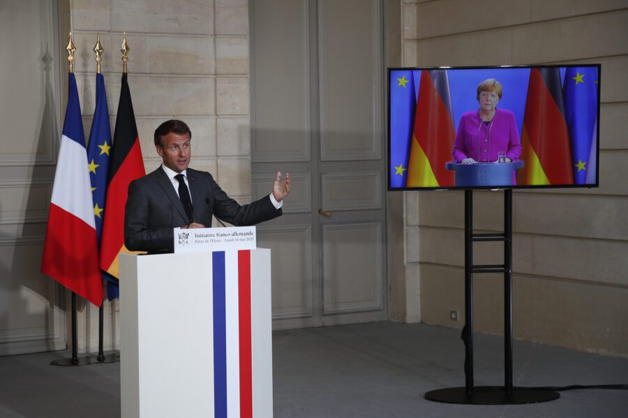 French President Emmanuel Macron speaks while German Chancellor Angela Merkel listens during a joint video press conference at the Elysee Palace Monday, May 18, 2020 in Paris. France and Germany discussed Europe’s economic recovery plans to respond to the virus crisis. (AP Photo/Francois Mori, Pool)