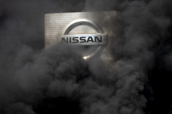 BARCELONA, SPAIN – MAY 28: The logo of Nissan is covered by smoke columns as employees burn tyres to protest against the closure of the Japanese cars manufacturer’s plant, where about 3,000 people are employed,  in Barcelona, Spain on May 28, 2020. (Photo by ADRIA PUIG/Anadolu Agency via Getty Images)
