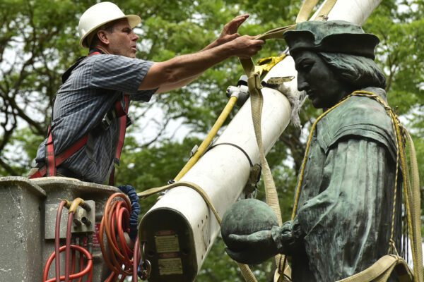 The statue of Christopher Columbus is removed from Wooster Square Park, in New Haven, Conn. Wednesday, June 24, 2020. (Peter Hvizdak/Hearst Connecticut Media via AP)
