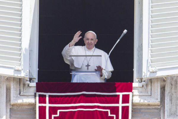Pope Francis waves to the faithful from the window of his studio overlooking St. Peter’s Square at the Vatican, Sunday, June 28, 2020. (AP Photo/Riccardo De Luca)