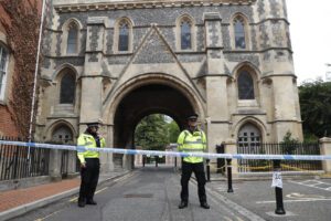 Police stand guard at the Abbey gateway of Forbury Gardens, a day after a multiple stabbing attack in the gardens in Reading, England, Sunday June 21, 2020. British police say they are treating a stabbing rampage in a park that killed three people as a terrorist attack. Dean Haydon, the U.K.’s coordinator of counterterrorism policing, said counterterror detectives were taking over the investigation into the attack in the town of Reading, west of London. (AP Photo/Alastair Grant)
