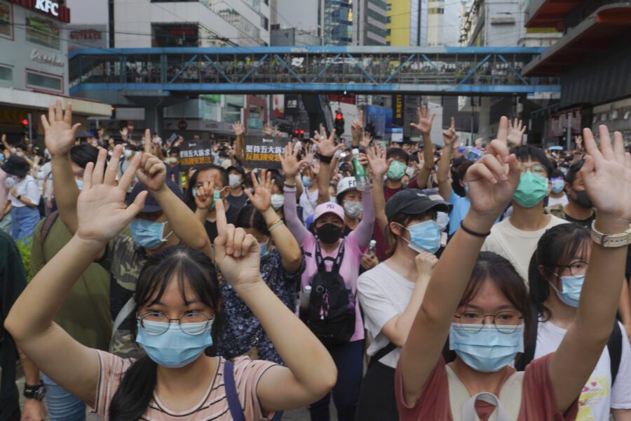 Protesters against the new national security law march and gesture with five fingers, signifying the "Five demands – not one less" on the anniversary of Hong Kong’s handover to China from Britain in Hong Kong, Wednesday, July. 1, 2020. Hong Kong marked the 23rd anniversary of its handover to China in 1997, and just one day after China enacted a national security law that cracks down on protests in the territory. (AP Photo/Vincent Yu)