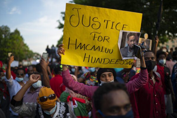 People walk along Lexington Avenue after exiting off westbound Interstate 94 on Wednesday, July 1, 2020, in St. Paul, Minn. Protesters apparently outraged by the killing of Hachalu Hundessa, a popular singer in Ethiopia, stopped traffic on the interstate during the evening rush hour. Police blocked the entrance ramps to the freeway shortly before 6:30 p.m. Traffic was stopped as the group moved down the interstate. State Patrol spokesman Lt. Gordon Shank said after 8 p.m. the protesters had left the freeway, and no arrests have been made. (Jeff Wheeler/Star Tribune via AP)