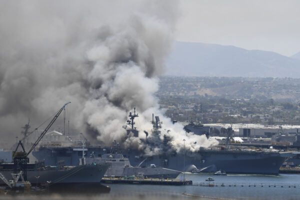 Smoke rises from the USS Bonhomme Richard at Naval Base San Diego Sunday, July 12, 2020, in San Diego after an explosion and fire Sunday on board the ship at Naval Base San Diego. (AP Photo/Denis Poroy)