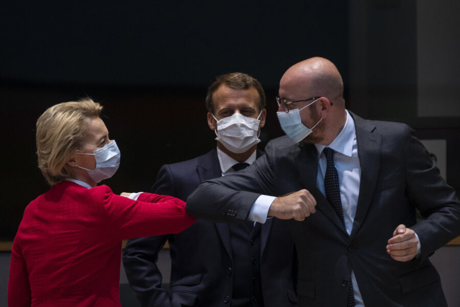 European Commission President Ursula von der Leyen, left, greets European Council President Charles Michel, right, with an elbow bump during a meeting on the sidelines of an EU summit in Brussels, Saturday, July 18, 2020. Leaders from 27 European Union nations meet face-to-face for a second day of an EU summit to assess an overall budget and recovery package spread over seven years estimated at some 1.75 trillion to 1.85 trillion euros. At center is French President Emmanuel Macron. (AP Photo/Francisco Seco, Pool)