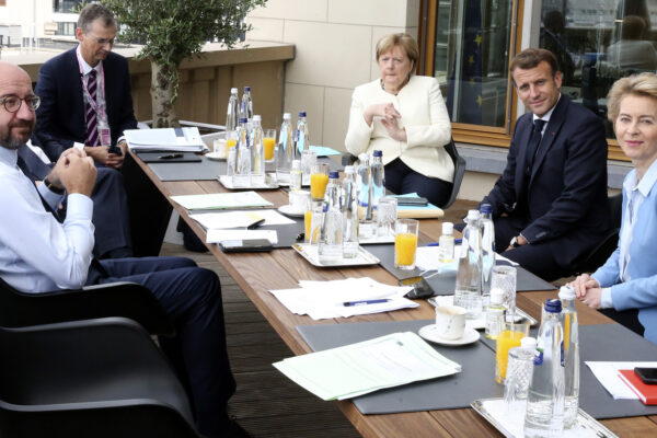 European Council President Charles Michel, left, poses for photographers with German Chancellor Angela Merkel, third right, French President Emmanuel Macron, second right and European Commission President Ursula von der Leyen, right, prior to a meeting on the sidelines of an EU summit at the European Council building in Brussels, Sunday, July 19, 2020. Leaders from 27 European Union nations meet face-to-face for a third day of an EU summit to assess an overall budget and recovery package spread over seven years estimated at some 1.75 trillion to 1.85 trillion euros. (AP Photo/Francois Walschaerts, Pool Photo via AP)