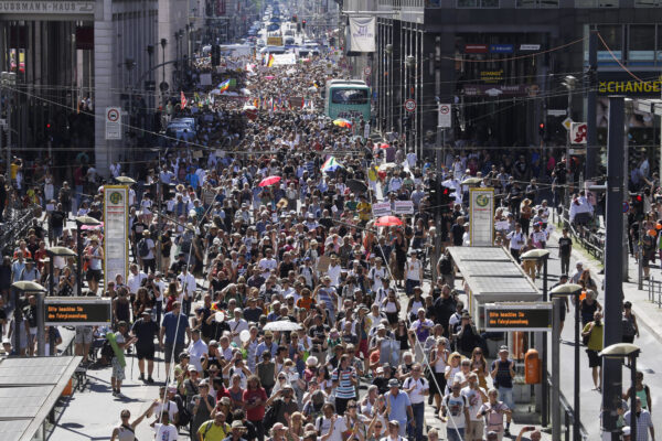 People mostly without face masks attend a demonstration with the slogan ‚The end of the pandemic – freedom day’ – against coronavirus restrictions in Berlin, Germany, Saturday, Aug. 1, 2020. It comes amid increasing concern about an upturn in infections in Germany. (AP Photo/Markus Schreiber)