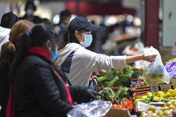 People shop at Queen Victoria Market hours before a citywide curfew is introduced in Melbourne, Sunday, August 2, 2020. The premier of Australia’s hard-hit Victoria state has declared a disaster among sweeping new coronavirus restrictions across Melbourne and elsewhere from Sunday night. (Erik Anderson/AAP Image via AP)