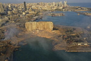 A drone picture shows the scene of an explosion that hit the seaport of Beirut, Lebanon, Wednesday, Aug. 5, 2020. A massive explosion rocked Beirut on Tuesday, flattening much of the city’s port, damaging buildings across the capital and sending a giant mushroom cloud into the sky. (AP Photo/Hussein Malla)