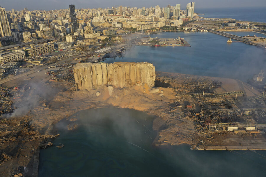 A drone picture shows the scene of an explosion that hit the seaport of Beirut, Lebanon, Wednesday, Aug. 5, 2020. A massive explosion rocked Beirut on Tuesday, flattening much of the city’s port, damaging buildings across the capital and sending a giant mushroom cloud into the sky. (AP Photo/Hussein Malla)