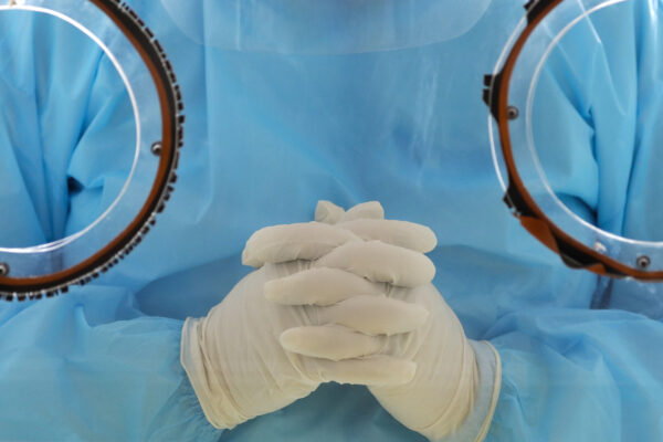 A health worker prays as a catholic priest blesses the COVID19 swab test area of a hospital in Manila, Philippines on Thursday, Aug. 6, 2020. The capital and outlying provinces returned to another lockdown after medical groups warned that the country was waging a losing battle against the coronavirus amid an alarming surge in infections. (AP Photo/Aaron Favila)