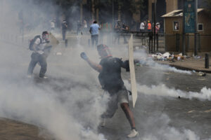 People clash with police during a protest against the political elites and the government after this week’s deadly explosion at Beirut port which devastated large parts of the capital and killed more than 150 people, in Beirut, Lebanon, Saturday, Aug. 8, 2020. (AP Photo/Hassan Ammar)