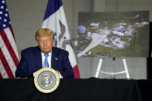 President Donald Trump listens during a briefing on Iowa flood damage and recovery efforts, Tuesday, Aug. 18, 2020, in Cedar Rapids, Iowa. (AP Photo/Evan Vucci)
