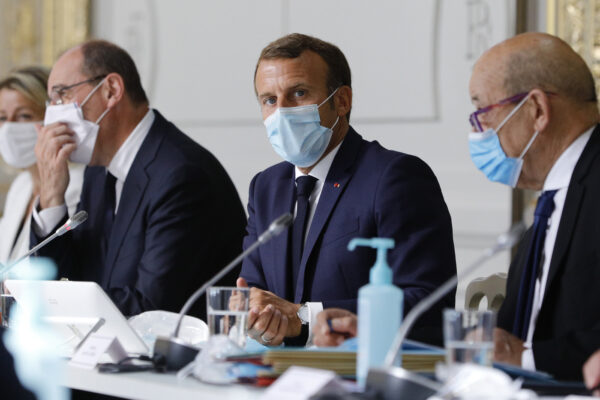 French President Emmanuel Macron, center, chairs a weekly cabinet meeting with Prime Minister Jean Castex, left, and Foreign Minister Jean-Yves le Drian, Wednesday, Aug.26, 2020 at the Elysee Palace in Paris. (AP Photo/Kamil Zihnioglu, Pool)