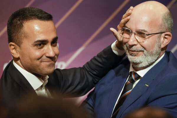 Italy’s Foreign Minister and 5-Star Movement leader Luigi Di Maio, left, embraces his successor Vito Crimi at a meeting in Rome, Wednesday, Jan. 22, 2020, where Di Maio stepped down as party leader following a string of parliamentary defections, falling poll numbers and questions about the movement’s future. Luigi Di Maio said he had finished his work, that an era had ended, and that he would trust his successor to lead the party going forward. (AP Photo/Andrew Medichini)