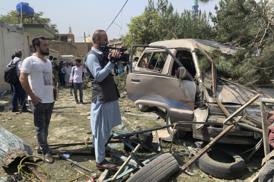 A cameraman scans the scene of an explosion in Kabul, Afghanistan, Wednesday, Sept. 9, 2020. A spokesman for Afghanistan’s Interior Ministry said the bombing that targeted the convoy of the country’s first vice president on Wednesday morning killed several people and wounded more than a dozen others, including several of the vice president’s bodyguards. (AP Photo/Rahmat Gul)
