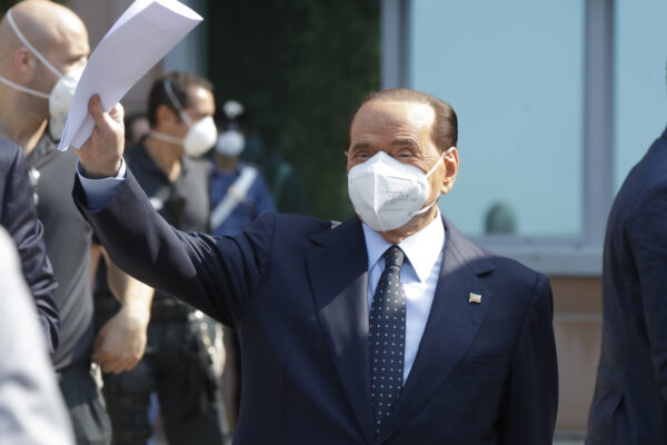 Italian former Premier Silvio Berlusconi waves as he leaves the San Raffaele hospital in Milan, Italy, Monday, Sept. 14, 2020. Berlusconi had been hospitalized as a precaution to monitor his coronavirus infection after testing positive for COVID-19. (AP Photo/Luca Bruno)
