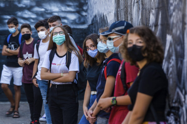 Pupils listen to teachers briefing them on the anti-COVID19 guidelines before they start their first day of school at the high school Giovanni Battista Morgagni in Rome, Monday, Sept. 14, 2020. The reopening of Italian schools, under anti-COVID19 guidelines, marks an important step in a return to pre-lockdown routine after 8 million school students endured Italy’s strict 2½-month lockdown, including the swift closure of schools followed by distance learning starting last March. (AP Photo/Domenico Stinellis)