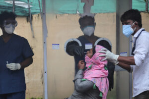 Health workers collect a nasal swab sample to test for COVID-19 in Hyderabad, India, Thursday, Sept. 17, 2020. As India’s coronavirus confirmed cases jump by a record 97,894 cases in the past 24 hours, Prime Minister Narendra Modi’s government faced a scathing opposition criticism in Parliament for its handling of the pandemic and a contracting economy leaving millions jobless on Thursday. (AP Photo/Mahesh Kumar A.)