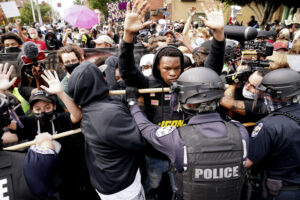Police and protesters converge during a demonstration, Wednesday, Sept. 23, 2020, in Louisville, Ky. A grand jury has indicted one officer on criminal charges six months after Breonna Taylor was fatally shot by police in Kentucky. The jury presented its decision against fired officer Brett Hankison Wednesday to a judge in Louisville, where the shooting took place. (AP Photo/John Minchillo)