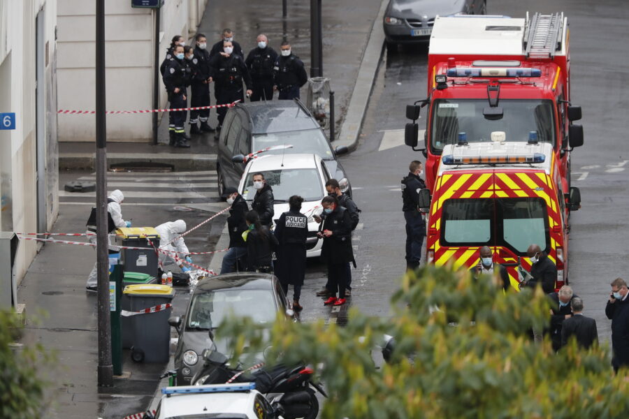 Police officers gather in the area of a knife attack near the former offices of satirical newspaper Charlie Hebdo, Friday Sept. 25, 2020 in Paris. Paris police say they have arrested a man suspected of a knife attack that wounded at least two people near the former offices of satirical newspaper Charlie Hebdo. Police initially thought there were two attackers but now say there was only one. (AP Photo/Thibault Camus)