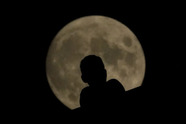 A man watches as the full moon rises Sunday, Aug. 2, 2020, in Kansas City, Mo. (AP Photo/Charlie Riedel) A man watches as the full moon rises Sunday, Aug. 2, 2020, in Kansas City, Mo. (AP Photo/Charlie Riedel)