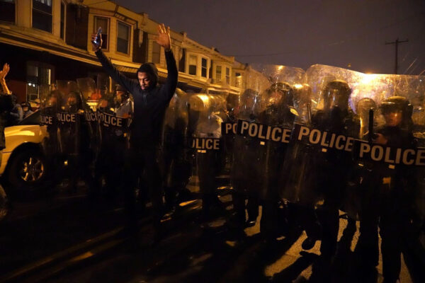 Sharif Proctor lifts his hands up in front of the police line during a protest in response to the police shooting of Walter Wallace Jr., Monday, Oct. 26, 2020, in Philadelphia. Police officers fatally shot the 27-year-old Black man during a confrontation Monday afternoon in West Philadelphia that quickly raised tensions in the neighborhood. (Jessica Griffin/The Philadelphia Inquirer via AP)