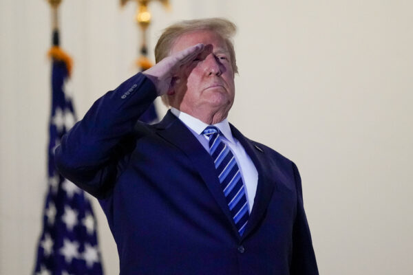 President Donald Trump salutes to Marine One as he stands on the balcony outside of the Blue Room as returns to the White House Monday, Oct. 5, 2020, in Washington, after leaving Walter Reed National Military Medical Center, in Bethesda, Md. Trump announced he tested positive for COVID-19 on Oct. 2. (AP Photo/Alex Brandon)
