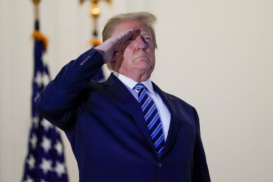 President Donald Trump salutes to Marine One as he stands on the balcony outside of the Blue Room as returns to the White House Monday, Oct. 5, 2020, in Washington, after leaving Walter Reed National Military Medical Center, in Bethesda, Md. Trump announced he tested positive for COVID-19 on Oct. 2. (AP Photo/Alex Brandon)