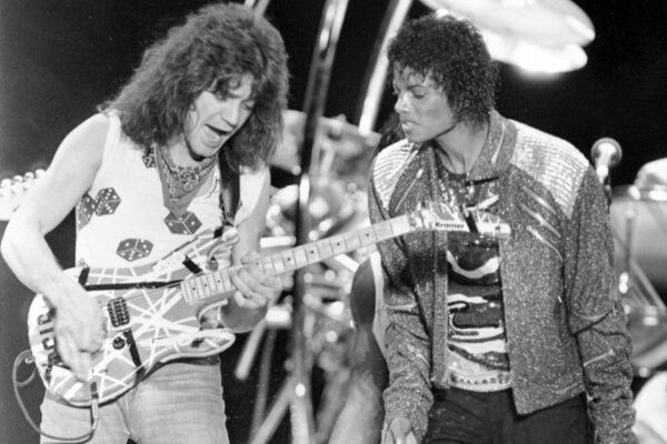 FILE – This July 14, 1984 file photo shows Van Halen guitarist Eddie Van Halen, left, performing "Beat It" with Michael Jackson during Jackson’s Victory Tour concert in Irving, Texas. Van Halen, who had battled mouth cancer, died Tuesday, Oct. 6, 2020. He was 65. (AP Photo/Carlos Osorio, File) FILE – This July 14, 1984 file photo shows Van Halen guitarist Eddie Van Halen, left, performing "Beat It" with Michael Jackson during Jackson’s Victory Tour concert in Irving, Texas. Van Halen, who had battled mouth cancer, died Tuesday, Oct. 6, 2020. He was 65. (AP Photo/Carlos Osorio, File)