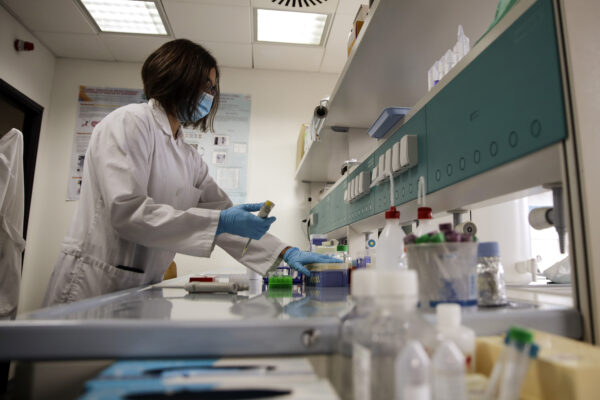Biochemical researcher Tiziana Alberio works on sample of saliva at the Insubria university department of biomedical science and research in Busto Arsizio, Italy, Friday, Oct. 9, 2020. Researchers at Insubria University come up with rapid salivary test methodology with 93% sensitivity rate to Coronavirus. The non invasive action could help screen large group of population before entering closed area such as cinemas, theaters or shopping centers. (AP Photo/Luca Bruno)