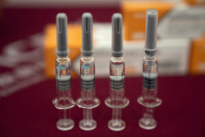In this Sept. 24, 2020, file photo, syringes of SARS CoV-2 Vaccine for COVID-19 produced by Sinovac are displayed during a media tour of its factory in Beijing. China is rapidly increasing the number of people receiving its experimental coronavirus vaccines, with a city offering one to the general public and a biotech company providing another free to students going abroad. (AP Photo/Ng Han Guan, File)