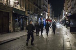 Police patrol in the streets as the curfew starts in Paris, Saturday, Oct. 17, 2020. French restaurants, cinemas and theaters are trying to figure out how to survive a new curfew aimed at stemming the flow of record new coronavirus infections. The monthlong curfew came into effect Friday at midnight, and France is deploying 12,000 extra police to enforce it. (AP Photo/Lewis Joly)